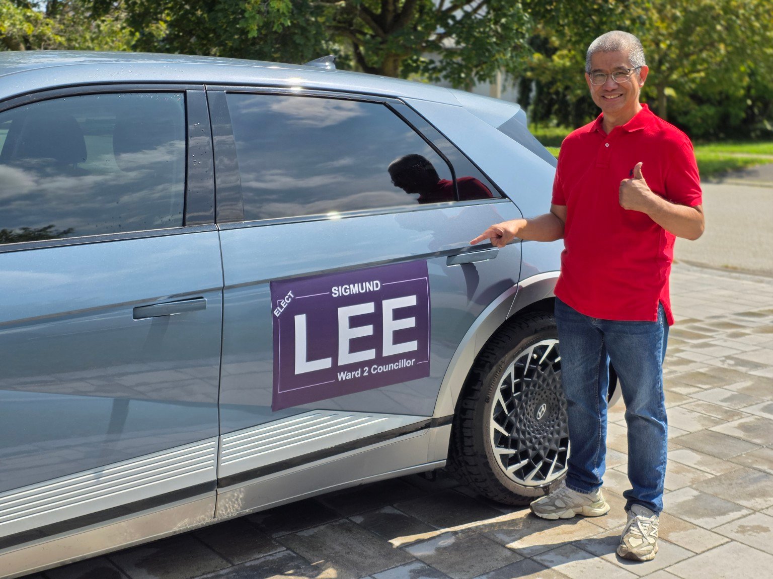 Sigmund Lee displaying a magnetic Ward 2 campaign sign on his vehicle
